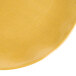 A yellow Thunder Group Gold Pearl salad plate on a white background.