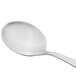 A silver Libbey bouillon spoon with a white handle.