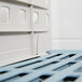 A close-up of a blue plastic crate divider for a MetroMax Q shelf.