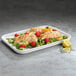A Villeroy & Boch white porcelain rectangular serving plate with vegetables and fish.
