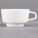 A close-up of a white Villeroy & Boch porcelain cup with a handle.