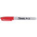 A red Sharpie permanent marker with a white cap and tip.