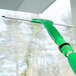 A green Unger UnitecLite window squeegee with a plastic handle