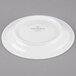 A white Villeroy & Boch porcelain saucer with a white rim and logo on it.