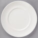 A white Villeroy & Boch porcelain plate with a thin rim on a gray surface.
