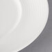 A close-up of a Villeroy & Boch white porcelain plate with a thin rim.