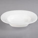 A white porcelain oval bowl on a gray surface.