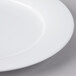 A close-up of a Villeroy & Boch white porcelain plate with a white rim.
