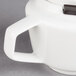 A Villeroy & Boch white porcelain teapot with a handle and lid.