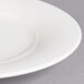 A close-up of a Villeroy & Boch white porcelain plate with a white rim.
