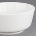 A white Villeroy & Boch porcelain bowl with a white rim on a gray surface.