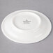 A white Villeroy & Boch porcelain saucer with black text on it.