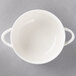 A white Villeroy & Boch porcelain soup cup with two handles.