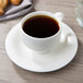 A Villeroy & Boch white porcelain cup of coffee on a saucer.