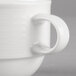 A close-up of a Villeroy & Boch white porcelain stackable mug with a handle.