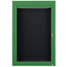A green cabinet with a black door containing a black letter board.