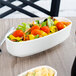 A white porcelain Villeroy & Boch bowl filled with salad on a table.