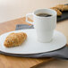 A Villeroy & Boch white porcelain mug filled with coffee on a plate with a croissant.