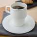A white Villeroy & Boch stackable mug with a drink in it.
