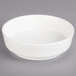 A white bowl on a gray surface.