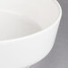 A close-up of a white Villeroy & Boch porcelain salad bowl with a white rim.