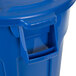 A blue Rubbermaid BRUTE trash can with a lid.
