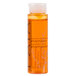 A close up of a PAYA Papaya Shampoo bottle filled with orange liquid.