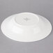 A white porcelain deep plate with a small white rim.