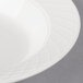 A close-up of a Villeroy & Boch white porcelain deep plate with a pattern.