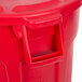 A red Rubbermaid BRUTE 44 gallon trash can with a lid.