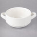 A close up of a white Villeroy & Boch porcelain soup bowl with two handles.