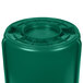 A green plastic Rubbermaid BRUTE barrel with a white lid.