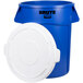 A blue plastic Rubbermaid BRUTE recycling can with a white lid.