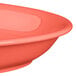 A bright orange Tuxton oval china platter on a counter.