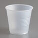 A Dart Conex translucent plastic cup on a gray surface.