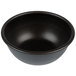 A Matfer Bourgeat Pomponnette mold in a black bowl on a white background.