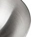 A close-up of a stainless steel hemisphere mold.