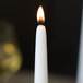 A close up of a Sterno white taper candle.