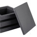 A stack of three black wooden display platters with one lid on top.