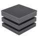 A stack of three Vollrath black wooden cube risers.
