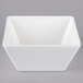 A white square Vollrath melamine bowl with a lid.
