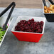 A Vollrath medium square melamine bowl filled with cranberries and salad.