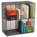 A black wire mesh shelf with colorful boxes and binders on it.