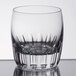 A close up of a clear Libbey Chisel Rocks glass with a curved edge.