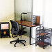 A cherry and black Safco steel workstation desk with a chair next to it.