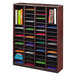 A Safco mahogany wood mail sorter with many different colored folders.