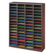 A Safco mahogany wood organizer with many sections holding colorful papers.