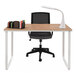 A beech and white Safco workstation with a chair and lamp on it.