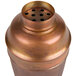 An American Metalcraft antique copper cobbler cocktail shaker with holes in it.