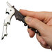 A hand holding a black and silver Pulltap's Slider Waiter's Corkscrew.